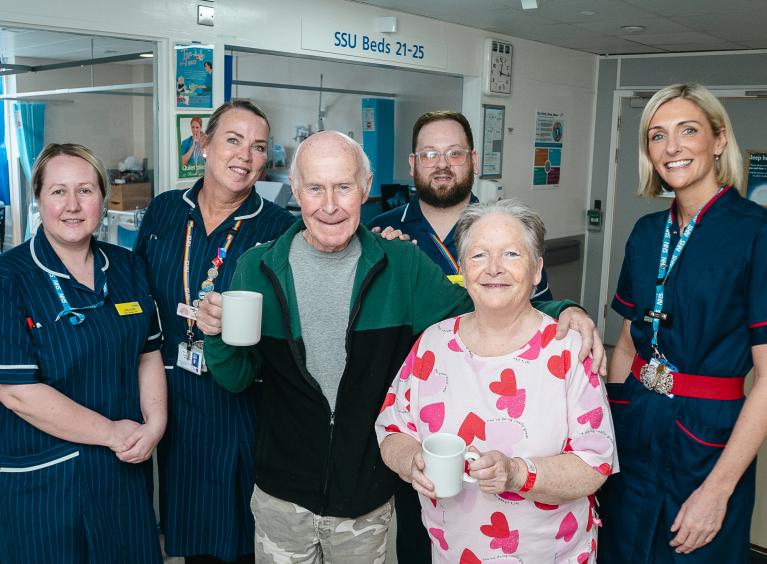 The image shows members of the B5 Ward team with a patient and their visitor.