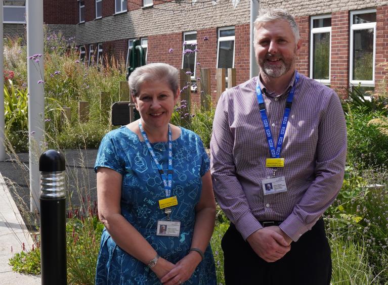 Two members of the Trust's health and safety team stood in a garden