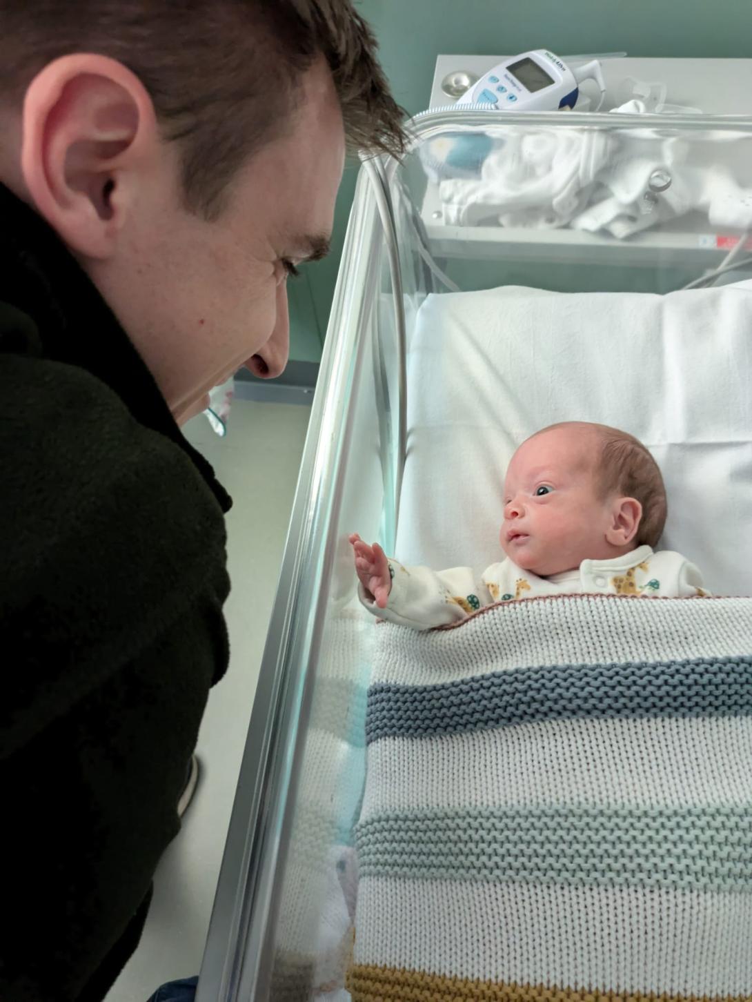 Baby James looking at his dad